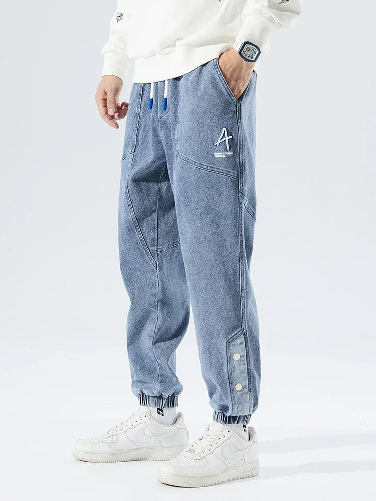 Men's Tapered Denim Joggers Featuring Panelled Seams And Elastic Waist
