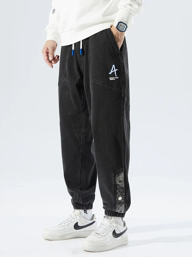 Men's Tapered Denim Joggers Featuring Panelled Seams And Elastic Waist
