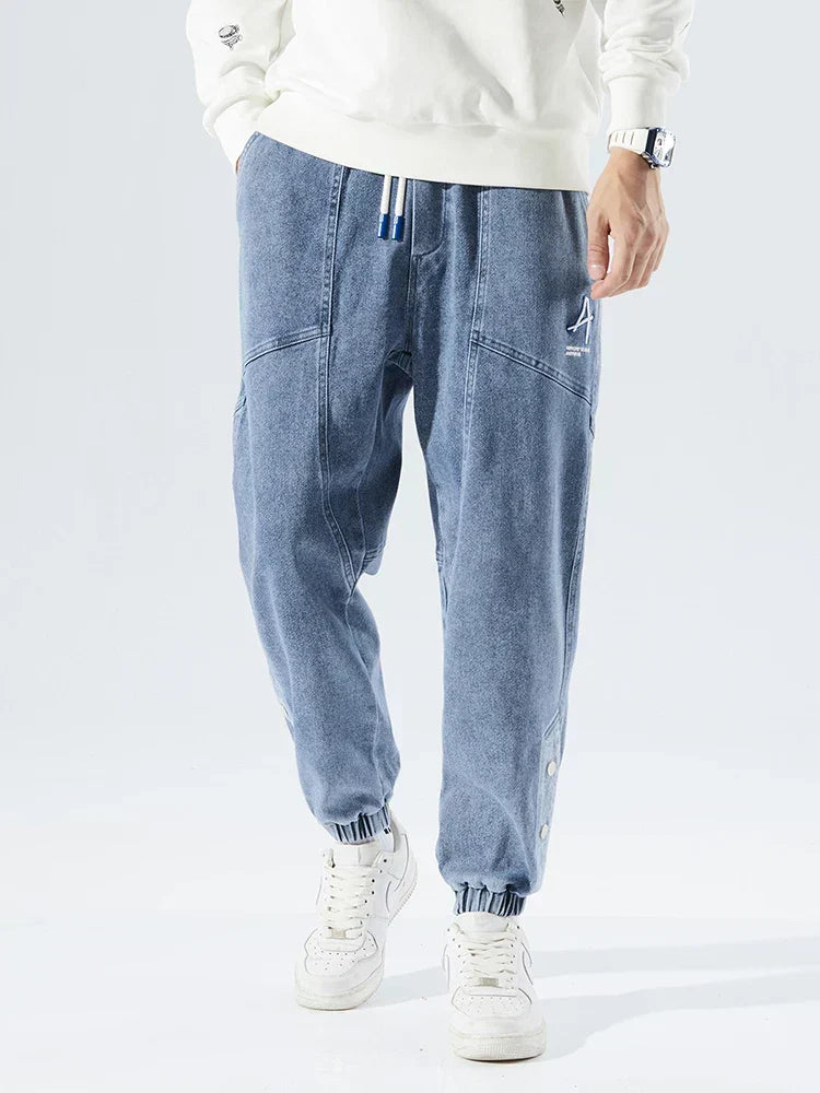 Men's Tapered Denim Joggers Featuring Panelled Seams And Elastic Waist