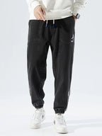 Men's Tapered Denim Joggers Featuring Panelled Seams And Elastic Waist