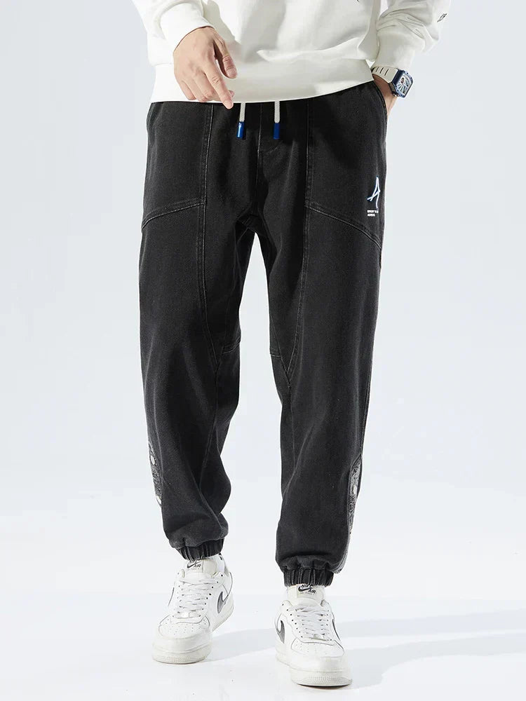 Men's Tapered Denim Joggers Featuring Panelled Seams And Elastic Waist